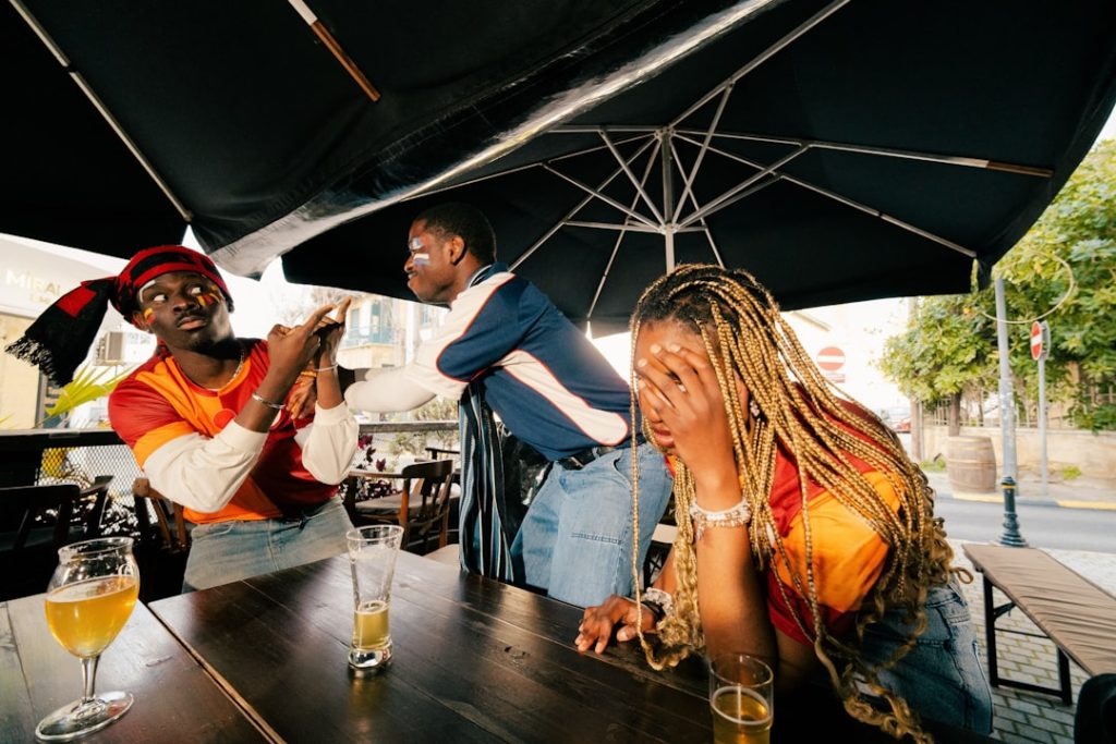 Three friends talking at an outdoor cafe