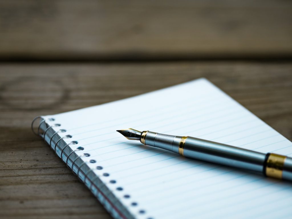 Fountain pen resting on an open notebook